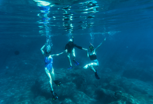Women on a Fish Ranch women's week trip cool off snorkeling while taking a break from their day on the water fly fishing 